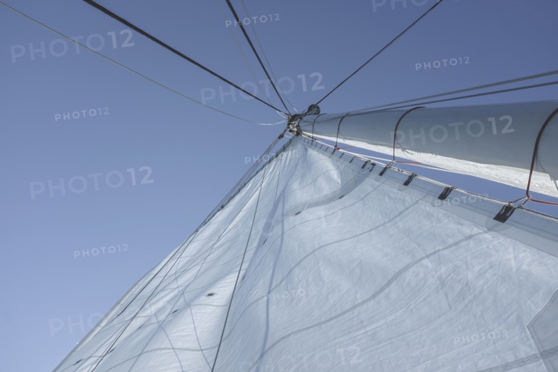 Low angle view of large sail and mast