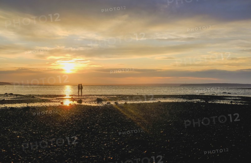 Couple on beach at sunset