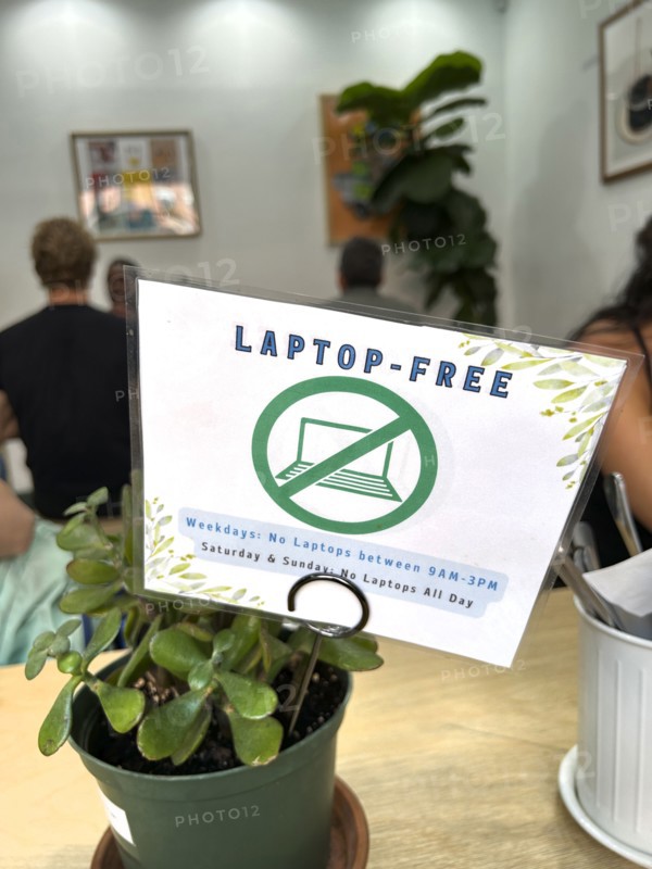 Laptop-Free Zone sign on café window