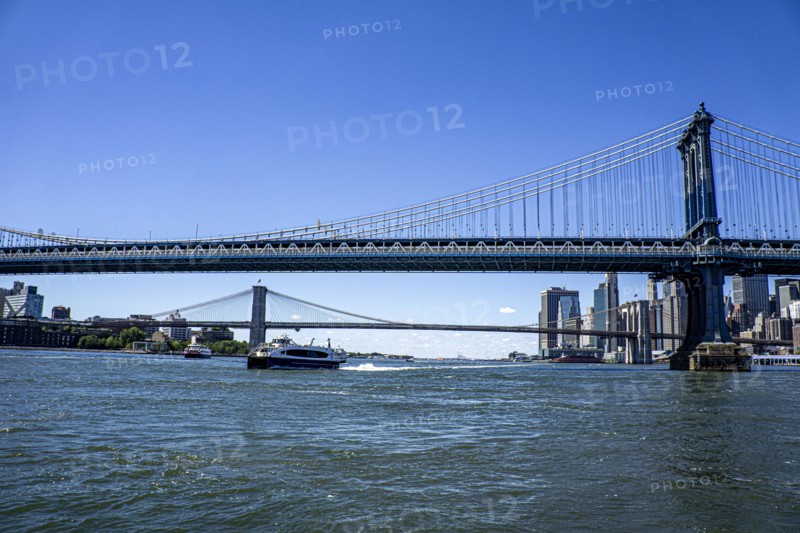 Manhattan (foreground) and Brooklyn (background) bridges crossing over East River with downtown Manhattan skyline in background (right), New York City, New York, USA