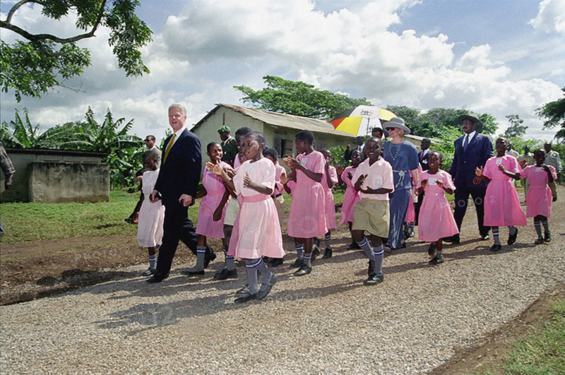 U.S. President Bill Clinton and U.S. First Lady Hillary Rodham Clinton walk with school children, Kisowera School, Mukono, Uganda, Barbara Kinney, White House Photograph Office, March 24, 1998