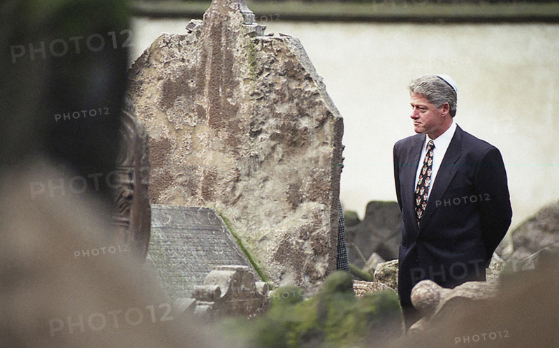 U.S. President Bill Clinton walking among graves during visit to historic Jewish cemetery, Prague, Czech Republic, Barbara Kinney, White House Photograph Office, January 12, 1994