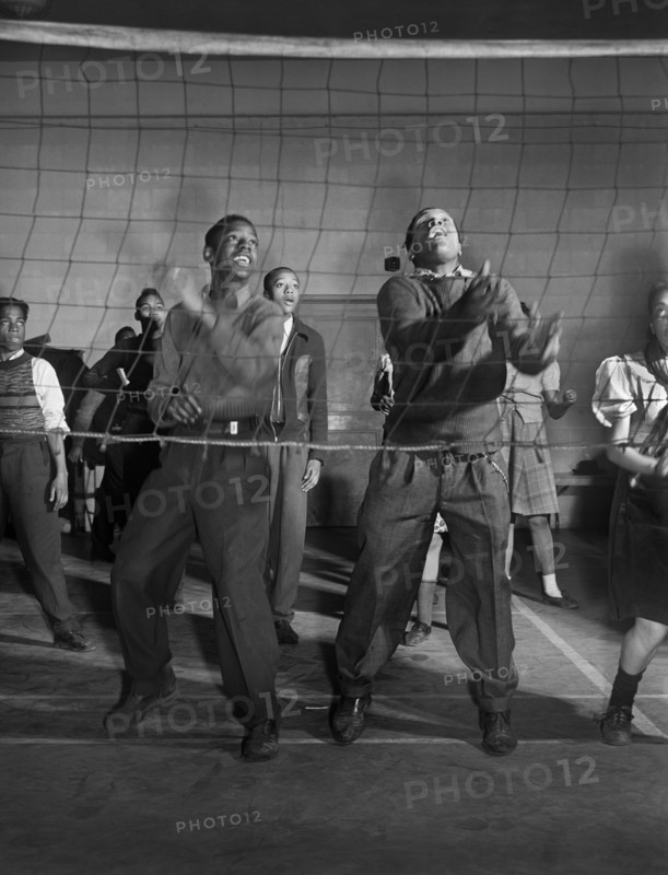 Young "Wellstowners" playing volleyball in recreation hall at community center, Ida B. Wells Housing Project, Chicago, Illinois, USA, Jack Delano, U.S. Farm Security Administration, March 1942