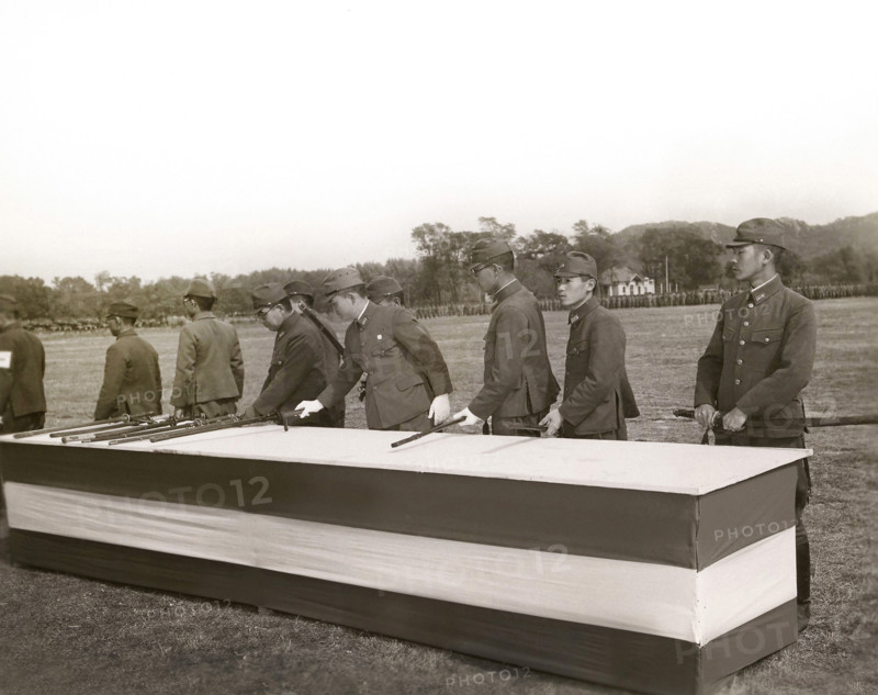 Japanese surrender party placing swords on table in final act of surrender in the presence (not shown) of Major General Lemuel C. Shepherd Jr., Commanding Officer of the Sixth Marine Division, and General Shen Pao Cheng, representing Chinese government, Qingdao, Shandong, China, Connolly, U.S. Marine Corps, October 25, 1945