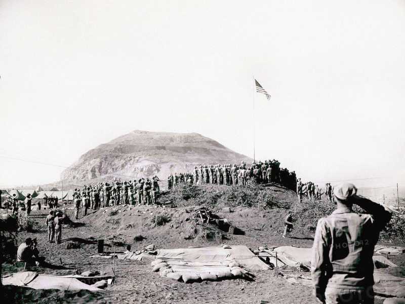 U.S. Marines of Fifth Marine Division raise American flag up flagpole after battle was won, Mount Suribachi, Iwo Jima, Dodd, U.S. Marine Corps, March 14, 1945