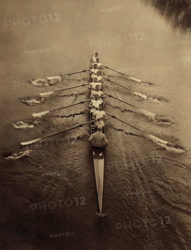 Eight rowers and coxswain rowing in sculling boat on river, Cambridge, England, UK, Bain News Service, 1910's