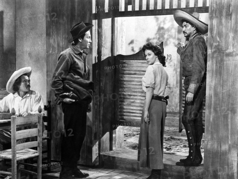 Cameron Mitchell (standing left), Susan Hayward, Victor Manuel Mendoza (standing right),  on-set of the western film, "Garden Of Evil", 20th Century-Fox, 1954