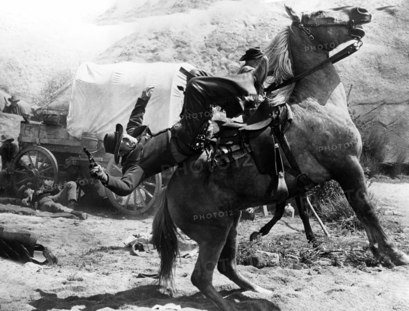 Cattle rustler being shot on horseback, on-set of the western film, "Gun For A Coward", Universal Pictures, 1957