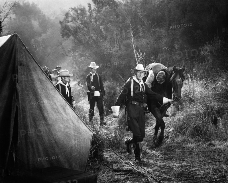 Roy Gordon (walking with horse), Richard Denning (injured on horse), on-set of the western film, "The Gun That Won The West", Columbia Pictures, 1955