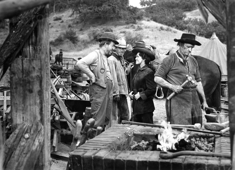 Jesse White (left), Susan Cabot, on-set of the western film, "Gunsmoke", Universal Pictures, 1953