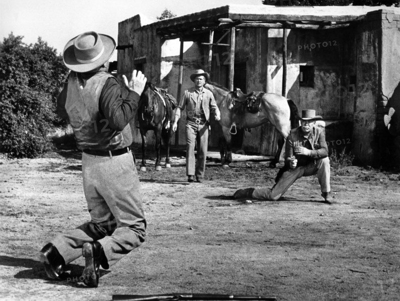 Jay C. Flippens (rear view,, on knees), Bill Williams (center), Ward Bond (right), on-set of the western film, "The Halliday Brand", United Artists, 1957