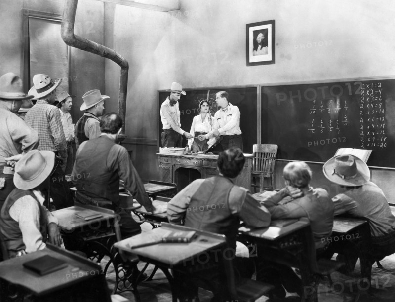 Lina Basquette (at desk, center), Hoot Gibson (at desk, right), on-set of the western film, "The Hard Hombre", Allied Pictures, 1931