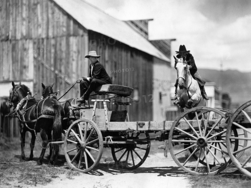 Fred Thomson (jumping over wagon on horse), on-set of the silent western film, "Jesse James", Paramount Pictures, 1927