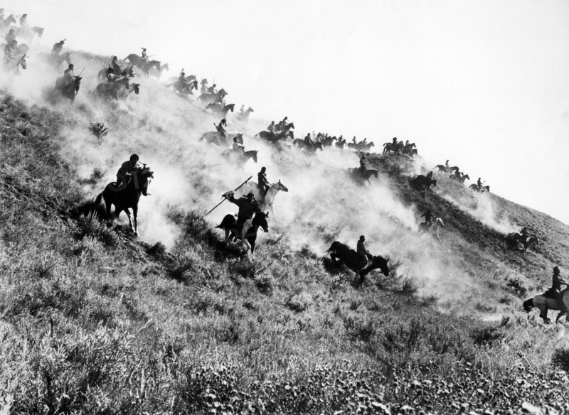 Native American fighters charging down hillside on horseback, on-set of the western  film, "Little Big Man", National General Pictures, 1970
