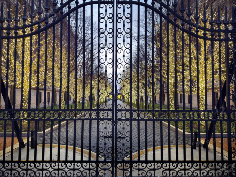 Entrance Gate at College Walk at dusk with illuminated lights wrapped around trees, Columbia University, New York City, New York, USA