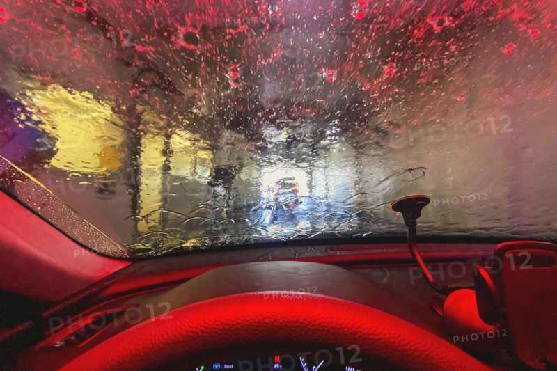View from car interior of car being washed at car wash
