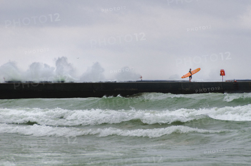 Surfer on Frankfort Pier, Lake Michigan.
