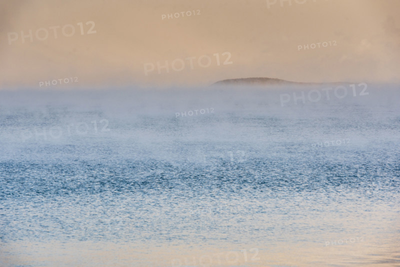 Fog on lake at sunrise