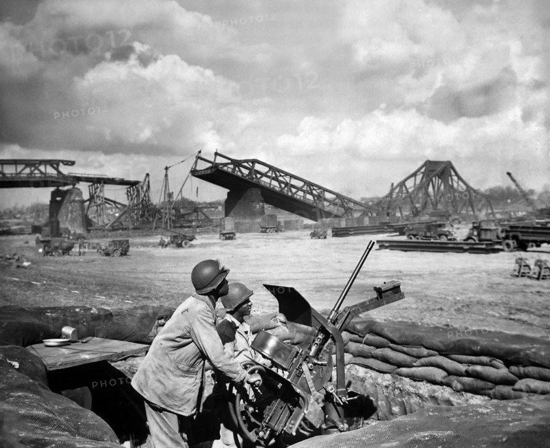 U.S. Privates George Cofield and Howard J. Davis guarding newly-constructed bridge site over Rhine River built by U.S. Ninth Army Engineers, Germany, U.S. Army Signal Corps, March 30, 1945