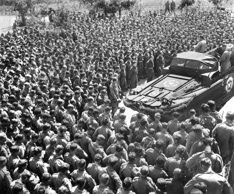 U.S. Lieutenant Colonel Woran, Chaplain of the 10th Mountain Division, leading group of men in prayer the day following the unconditional surrender of all German troops, Torboli (Nago-Torbole), Italy, U.S. Army Signal Corps, May 3, 1945