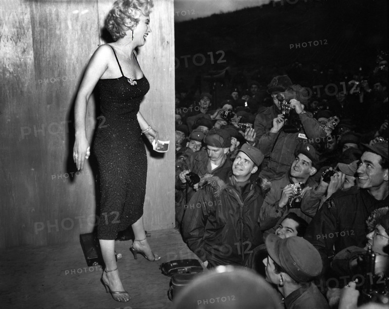 Marilyn Monroe, American motion picture actress, appearing with USO Camp Show, "Anything Goes," greeting soldiers after performance at 3rd U.S. Infantry Division area, South Korea, U.S. Army Signal Corps, February 17, 1954