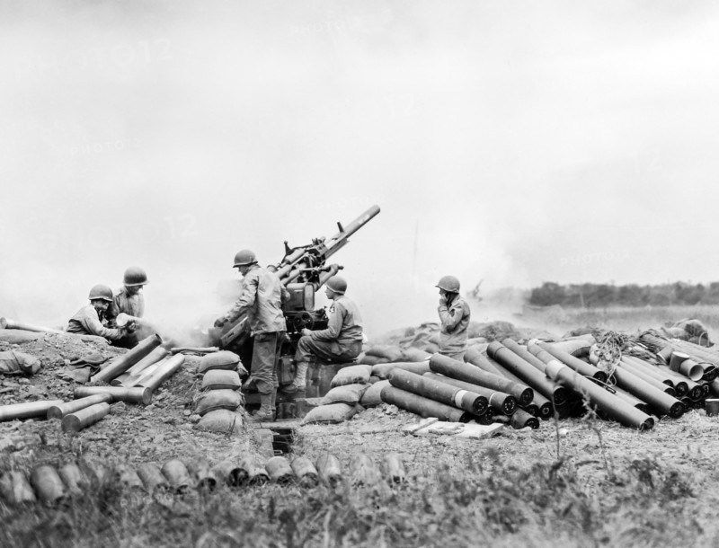 American gun battery of an anti-aircraft unit going into action on Omaha Beachhead, near Vierville Sur-mer, France, U.S. Army Signal Corps, June 10, 1944