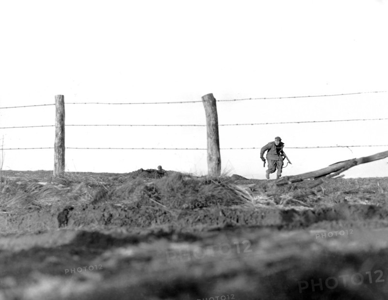 U.S. infantryman of 82nd Airborne Division, going on one-man sortie, covered by buddy in background, Belgium,  U.S. Army Signal Corps, Dec. 24, 1944