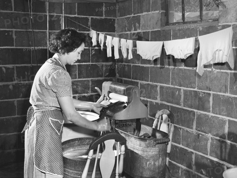 Woman wringing out washed clothes, Point Pleasant, West Virginia, USA, Arthur S. Siegel, U.S. Office of War Information, May 1943