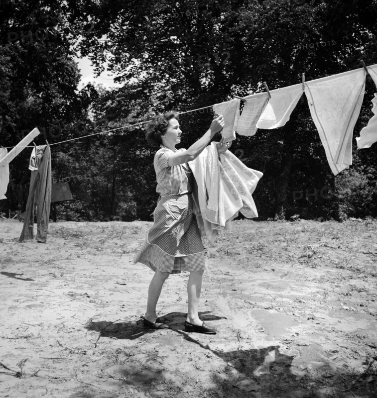 Woman removing laundry from clothes line, Point Pleasant, West Virginia, USA, Arthur S. Siegel, U.S. Office of War Information, May 1943