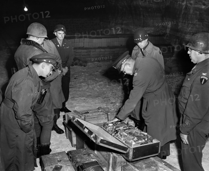 General Dwight D. Eisenhower, Supreme Allied Commander, and General Omar N. Bradley, CG, 12th Army Group, examine suitcase of silverware, part of German loot stored in Merkers salt mine, Germany, U.S. Army Signal Corps, April 12, 1945