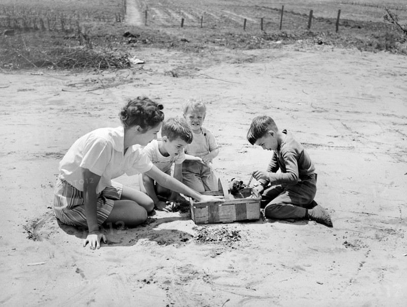 Woman and three children playing with puppy in basket, Point Pleasant, West Virginia, USA, Arthur S. Siegel, U.S. Office of War Information, May 1943