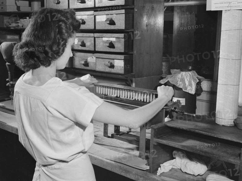 Female manufacturing chemist making wax capsules used for silver nitrate solution, Parke, Davis and Company, Detroit, Michigan, USA, Arthur S. Siegel, U.S. Office of War Information, May 1943