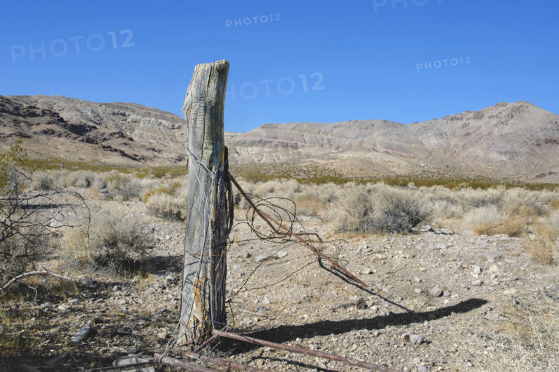 Old barbed wire fence post in ghost town, Rhyolite, Nevada, USA