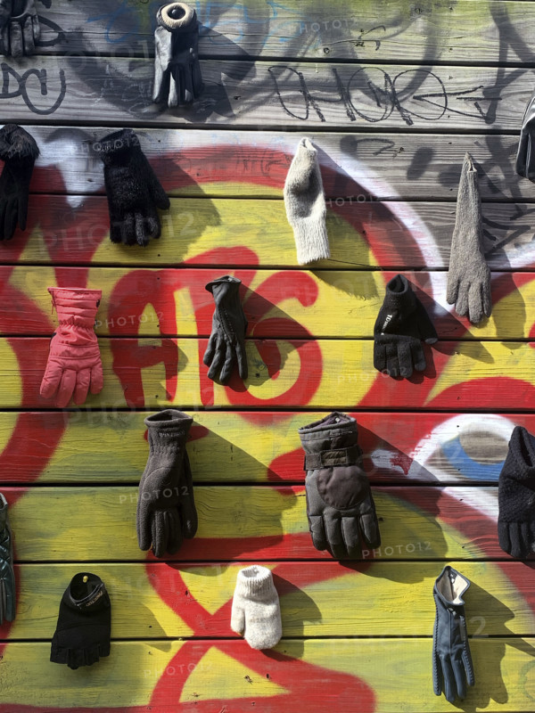 Lost gloves and mittens hanging on wood fence, Brooklyn, New York, USA