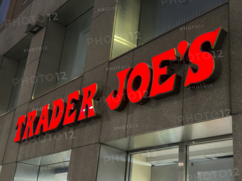 Trader Joe's grocery store, building exterior with company sign at night, New York City, New York, USA,