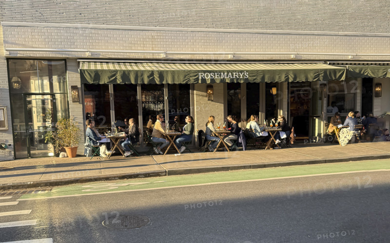 Group of people enjoying outdoor dining on sunny day, Rosemary's Restaurant, New York City, New York, USA