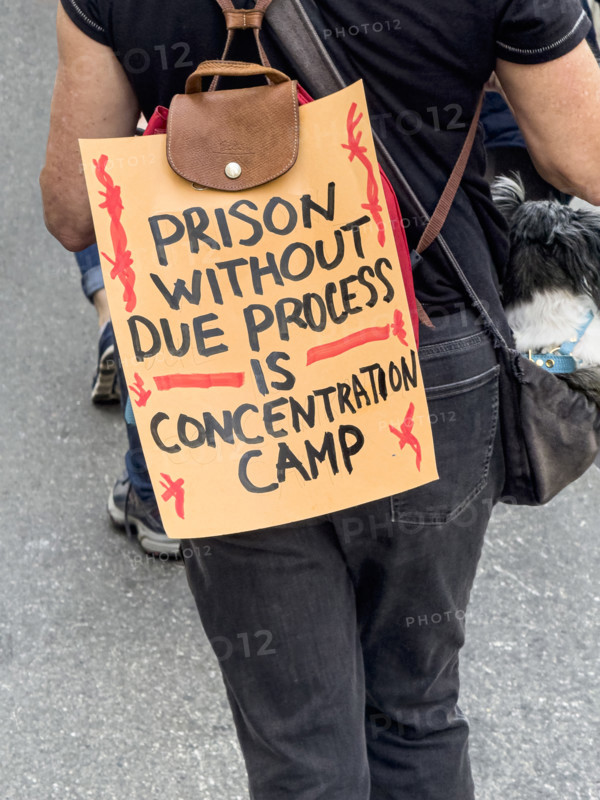 Demonstrator participating in "Our City, Our Fight: Protect Migrants, Protect the Planet" protest, New York City, New York, April 19, 2025