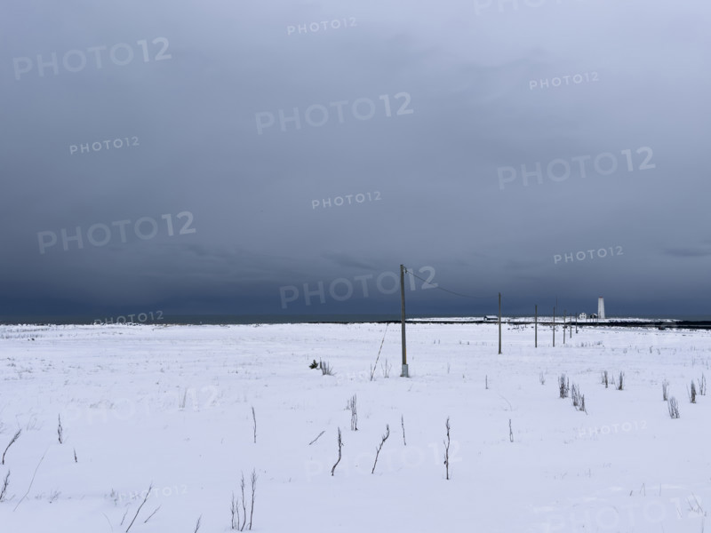 Snowy field with dramatic gray sky