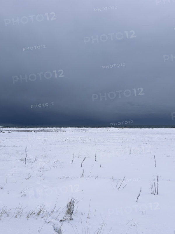 Snowy field with dramatic gray sky