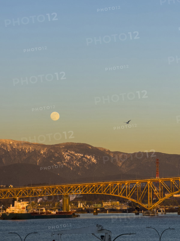 Full moon over Ironworkers Memorial Second Narrows Crossing, Burrard Inlet, and North Shore Mountains, North Vancouver, British Columbia, Canada