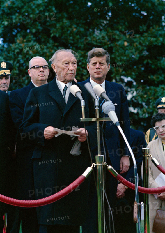 U.S. President John F. Kennedy looking on as Chancellor of West Germany, Dr. Konrad Adenauer, delivers remarks during arrival ceremonies in his honor, South Lawn, White House, Washington, D.C., USA, Robert Knudsen, White House Photographs, November 14, 1962