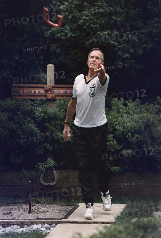 U.S. President George H.W. Bush participating in annual horseshoe tournament at the White House horseshoe pit, Washington, D.C., USA, David Valdez, White House photographer, June 24, 1992