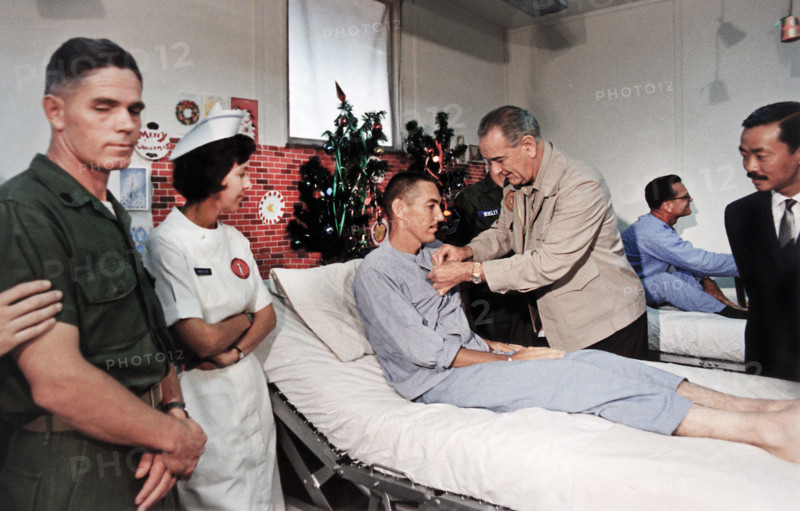 U.S. President Lyndon B. Johnson decorating a wounded U.S. soldier in military hospital, Cam Ranh Bay, Vietnam, Yoichi R. Okamoto, White House photographer, December 23, 1967