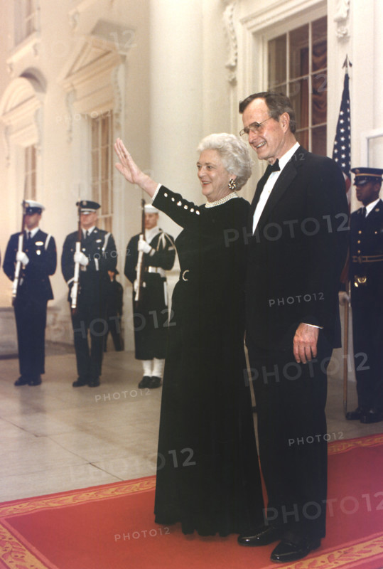 U.S. President George H.W. Bush and U.S. First Lady Barbara Bush await the arrival of President Ali Abdallah Saleh of the Yemen Arab Republic for a State Dinner at the White House, Washington, D.C., USA, Susan Biddle, White House photographer, January 24, 1990