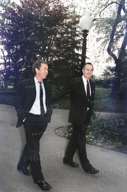 U.S. President George H.W. Bush walking up the south lawn towards the Oval Office with his son, George W. Bush, White House, Washington, D.C., USA, David Valdez, White House photographer, April 29, 1992