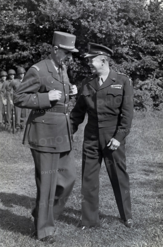 French General Charles de Gaulle, left, chatting with U.S. General Dwight D. Eisenhower during inspection of U.S. troops at the Allied commander's advance headquarters, Normandy, France, U.S. Army Signal Corps, August 22, 1944