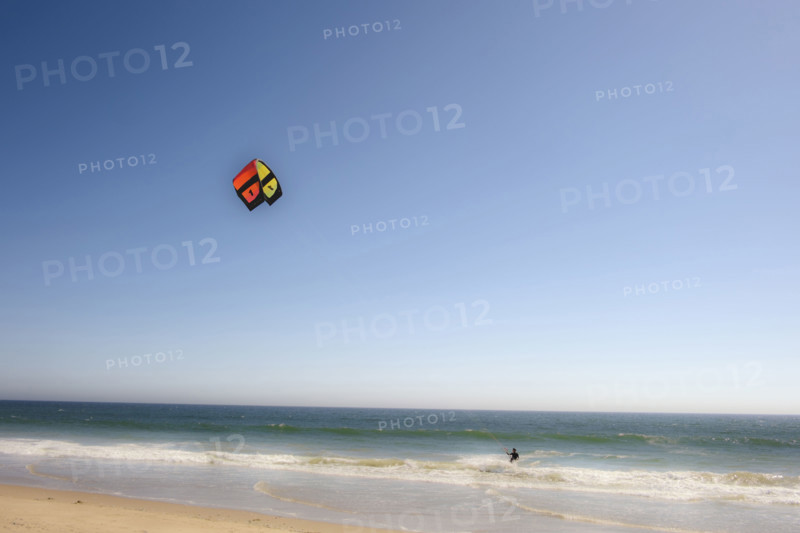 Kite surfer catching a wave