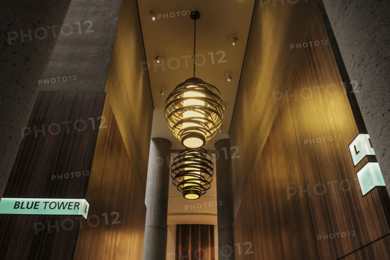 Two large spiral pendant lights in hotel lobby