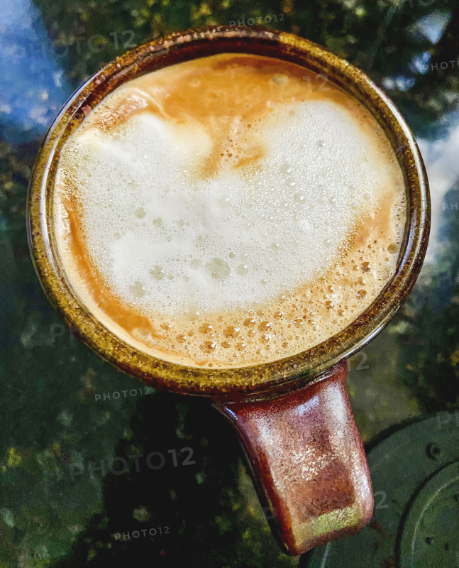 High angle view of brewed cappuccino with milk in cup