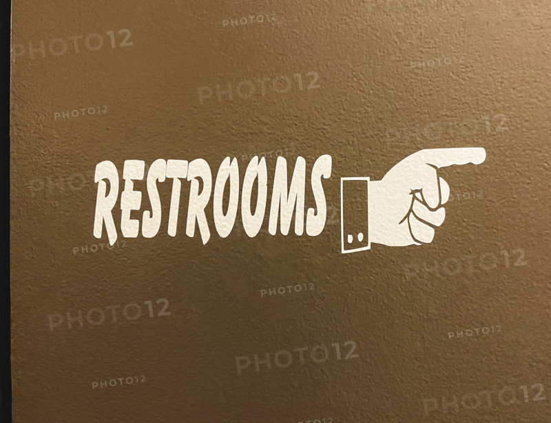 hand symbol pointing way to restrooms